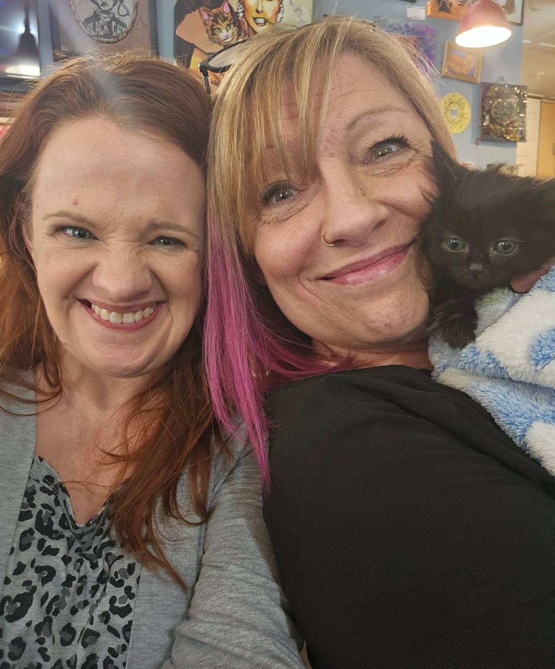 KJ and a guest with a tiny black kitten